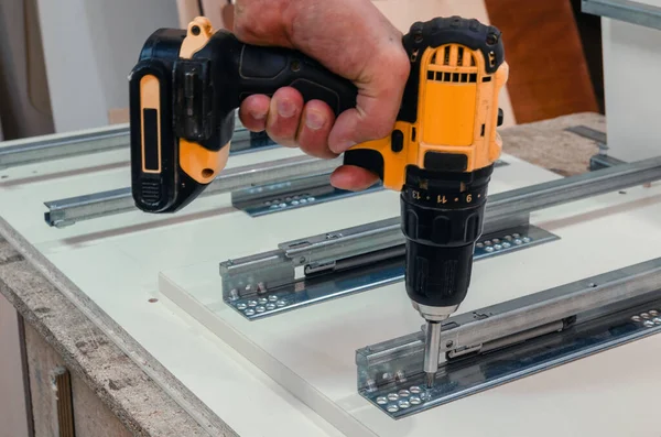 depositphotos_315117482-stock-photo-assembly-of-hard-furniture-close
